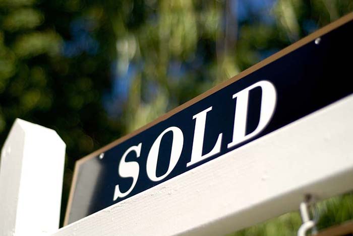 sold sign in front of house or condo